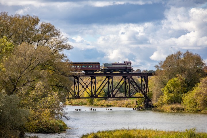 a train crossing a bridge over a body of water