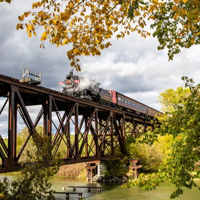 a train crossing a bridge over a body of water