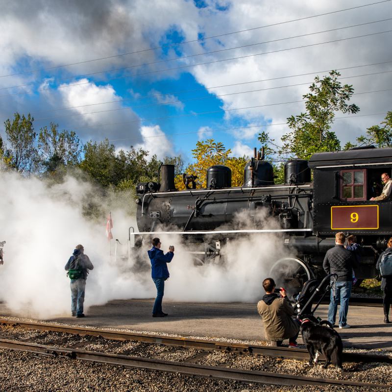 a train on a track with smoke coming out of it