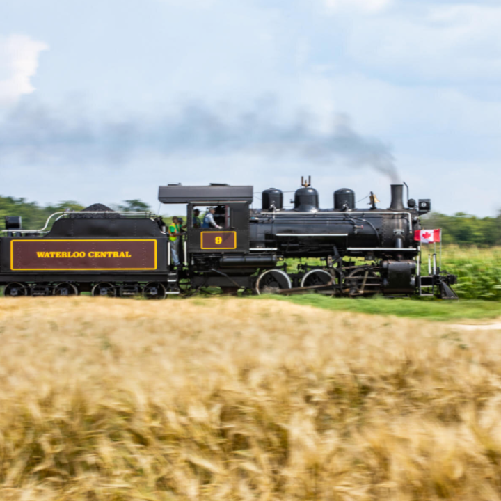 a train traveling down train tracks near a field