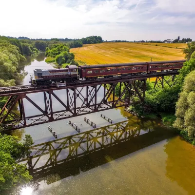 a train crossing a bridge over a body of water