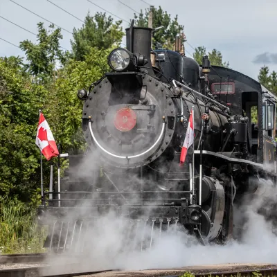 a steam train on a track with smoke coming out of it