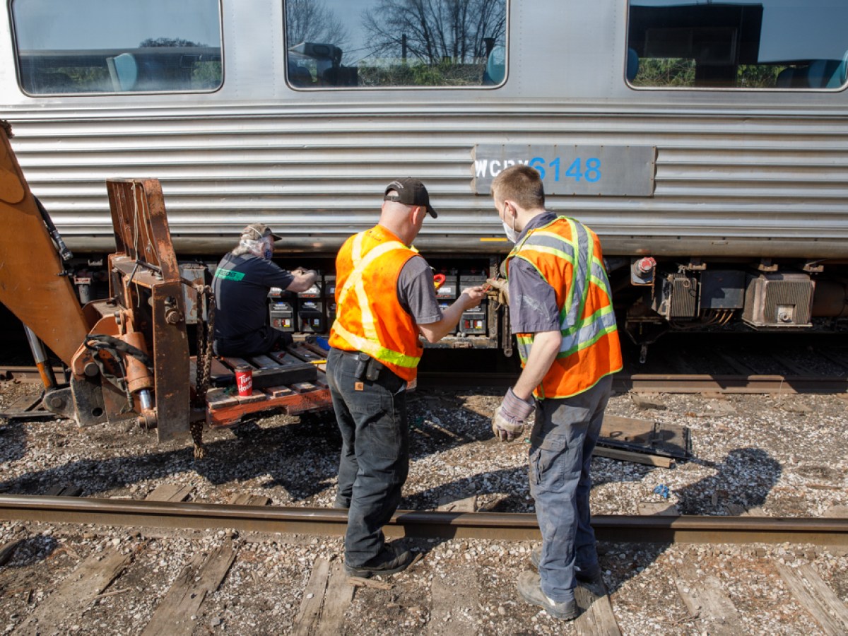 a man standing next to a train