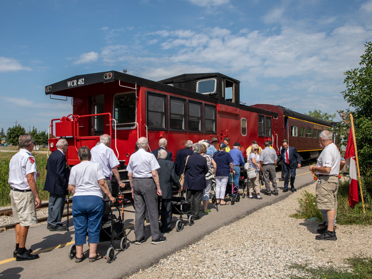 a group of people standing next to a train