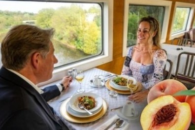 a person sitting at a table with a plate of food