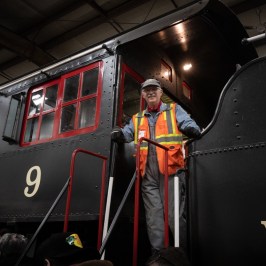 a person standing next to a train