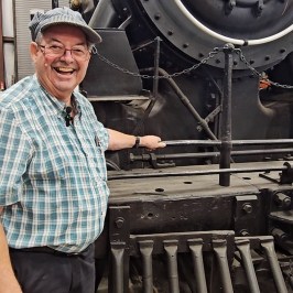 a man standing in front of a train