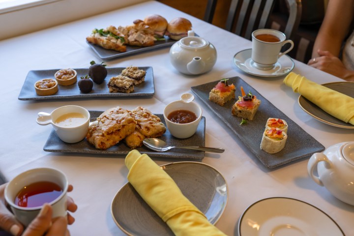 a group of people sitting at a table with a plate of food