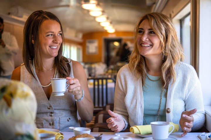 Simone Eli sitting at a table with a cup of coffee