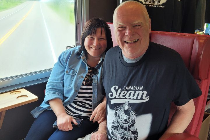 a man and woman sitting next to a window