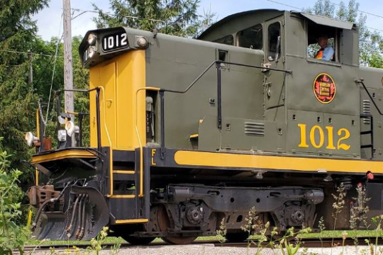 a train engine carrying carts down a track