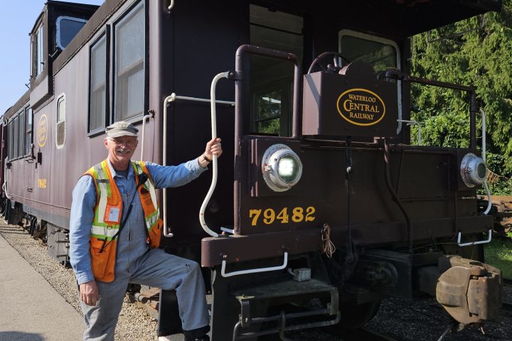 a man standing next to a train