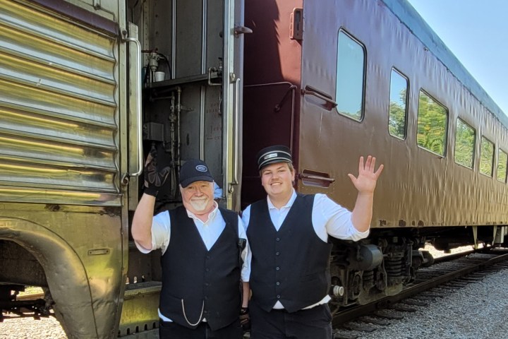 a person standing next to a train