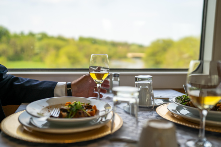 a person sitting at a table with a plate of food